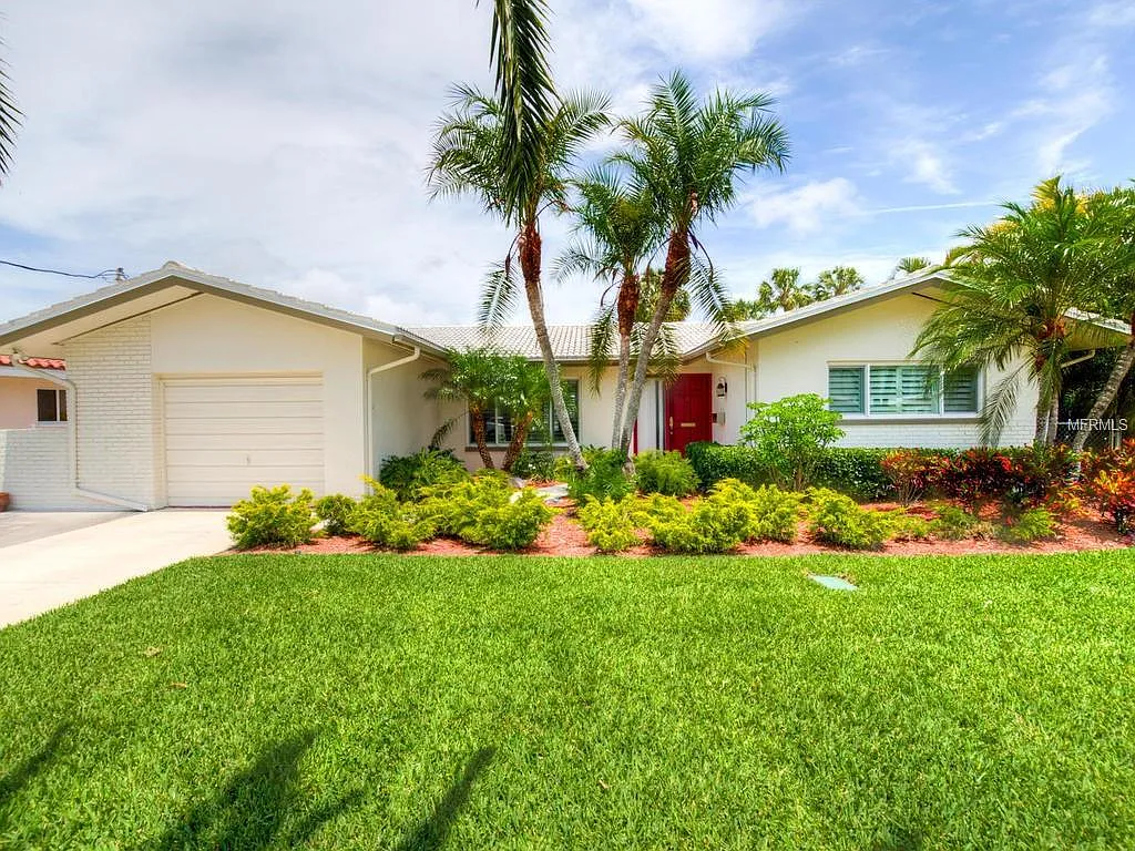 Palm Point front elevation with palms and lawn